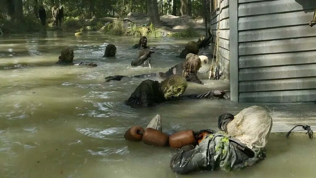 Zombies surround survivors hiding in a cabin.
