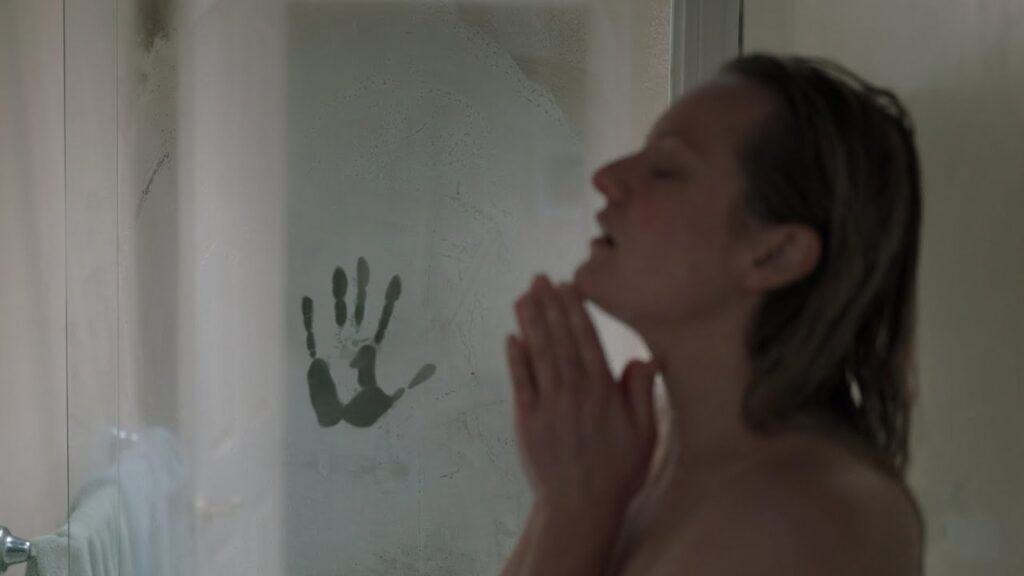 A woman is being peeked at by an invisible man while she is taking a shower.