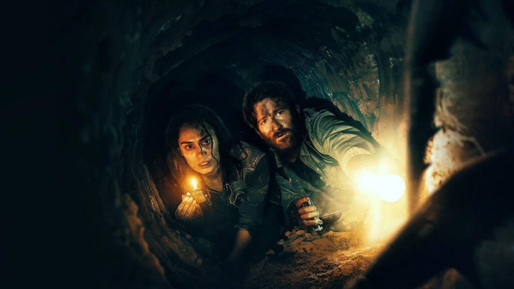 Two Survivors Crawl Underground While a Giant Tentacle Monster Stalks Them in the Dark.